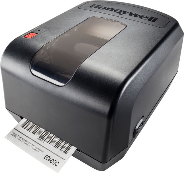 Honeywell PC42t Barcode Label Printer, a compact thermal transfer label printer, shown with a barcode printed on paper egressing from the printer.