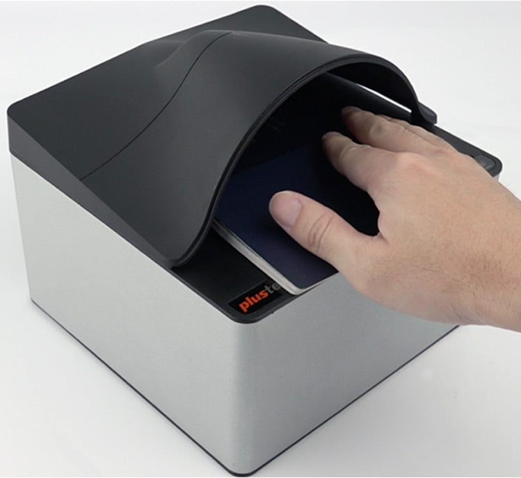 A hand is placing a document into the Plustek Secure Scan X50 scanner, which is gray and black in color.
