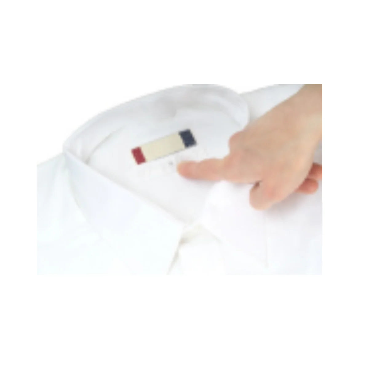 White shirt with a hand pointing to a label on a white background