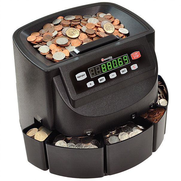 The image shows the Cassida Coin Max, a black coin counting machine with a digital display, buttons for navigation, and multiple coin trays.