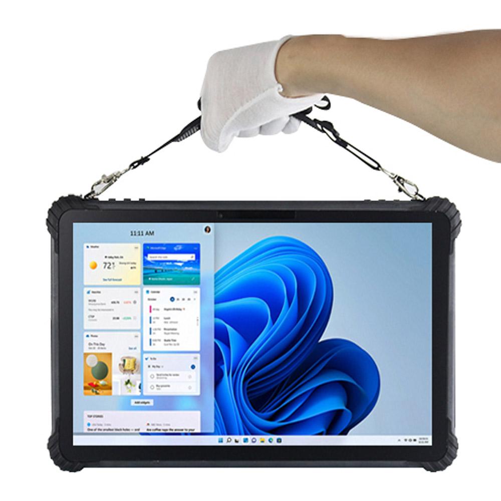 A rugged black tablet with a built-in handle, held by a white-gloved hand against a plain white background. The tablet screen is on, displaying a blue Windows 11-style wallpaper and several open application windows.