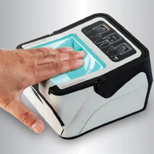 Hand pressing a button on a small electronic device with a screen.