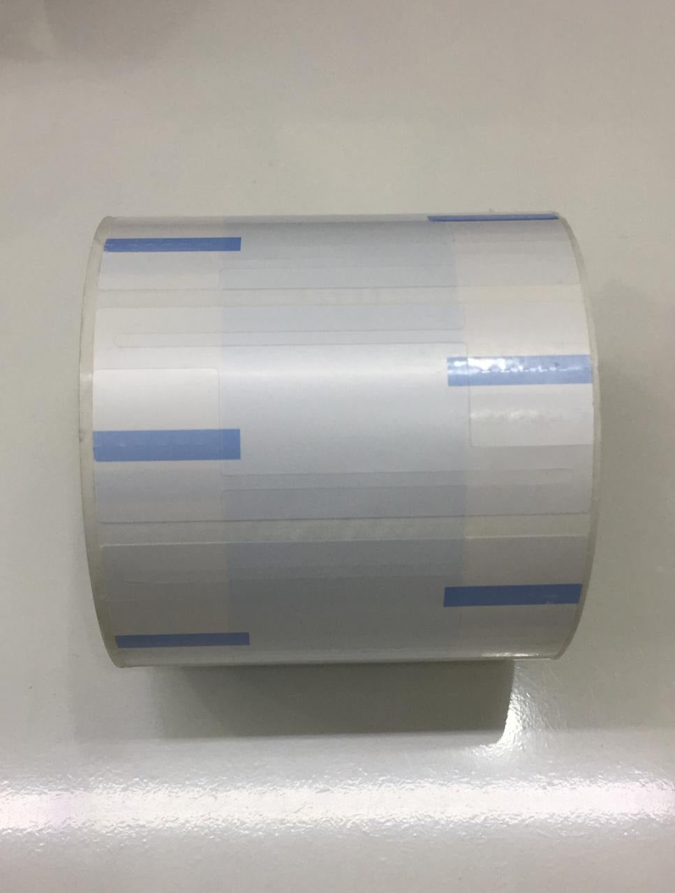 Roll of tape with blue stripes on a white background