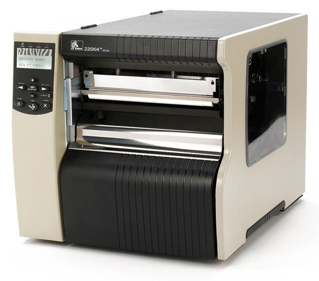 A Zebra 220Xi4 barcode label printer, showing a monochrome thermal transfer printer with a display and interface ports.