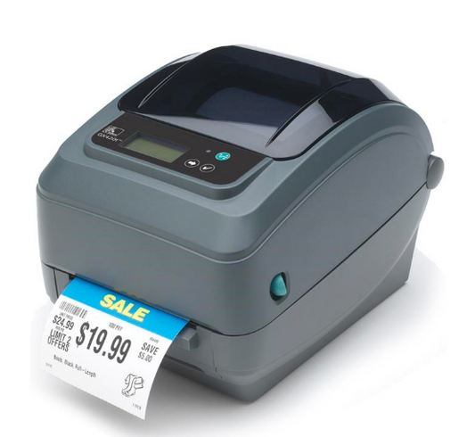 A Zebra GX420d barcode label printer in gray color, with a label partially dispensed from the printer.