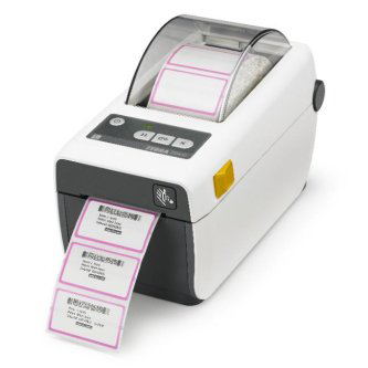 A Zebra ZD410 barcode label printer with labels coming out of the slot, showcasing its active printing function.